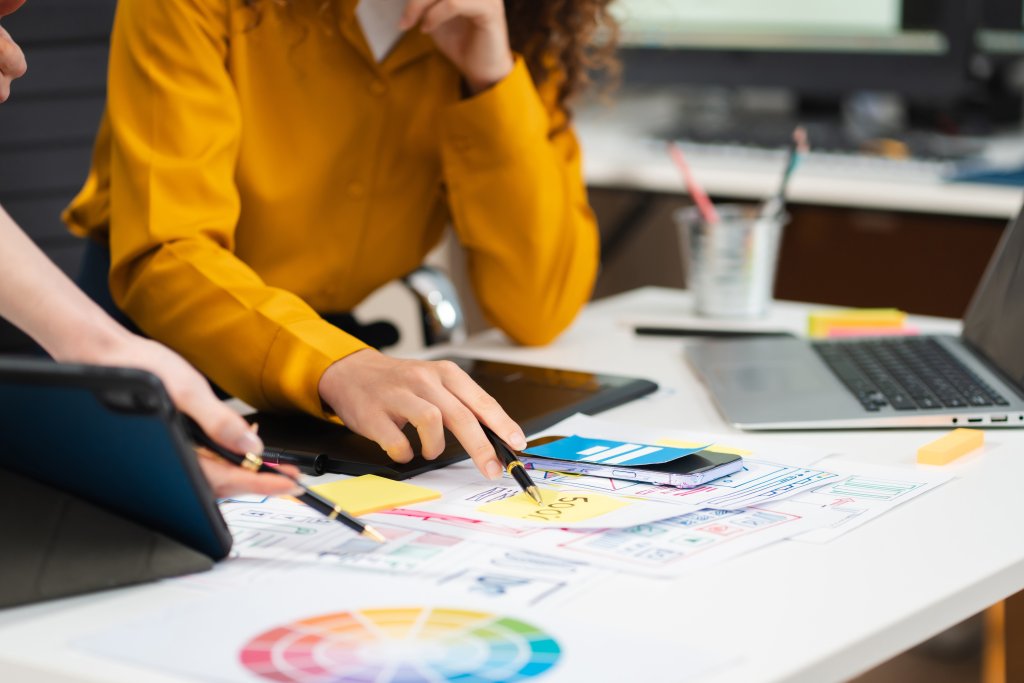 Designers planning website wireframe and colors