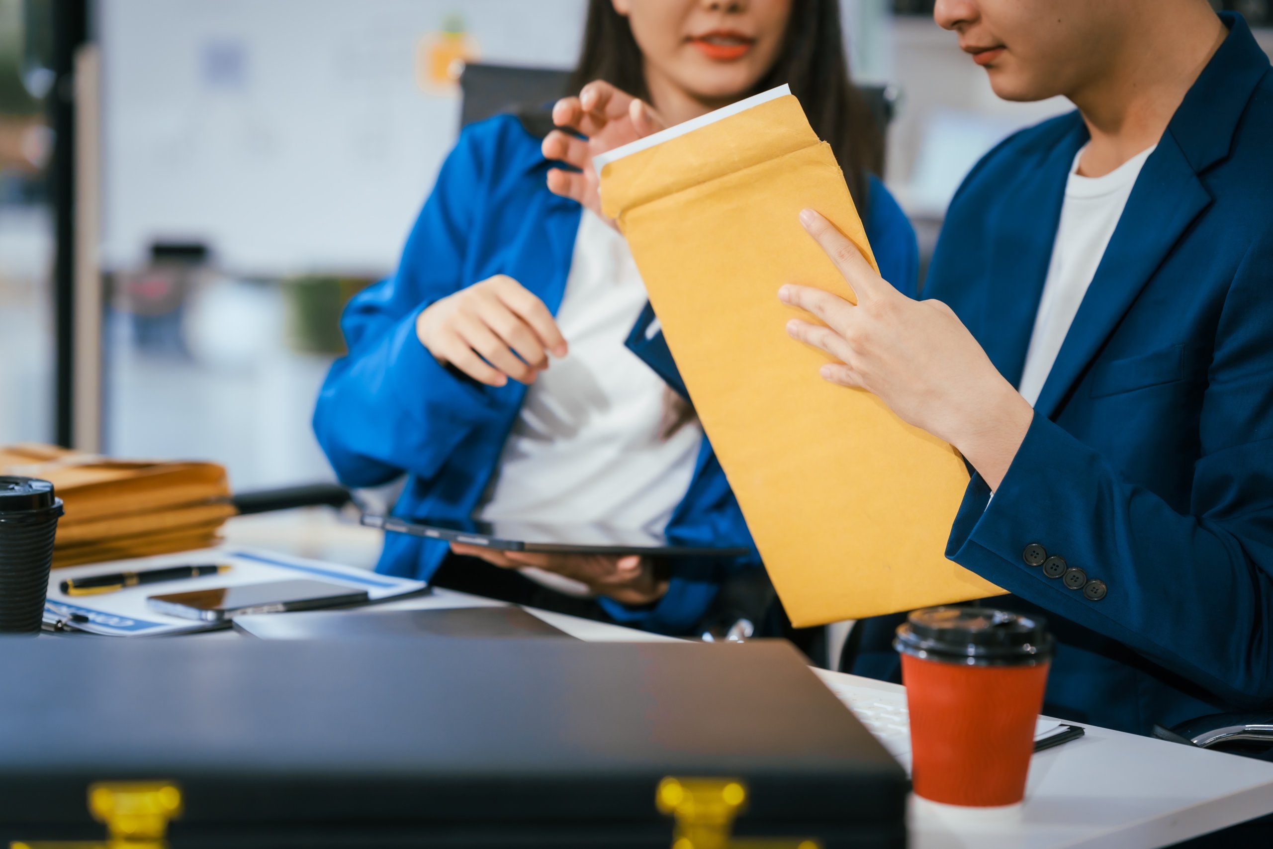 business professionals reviewing documents envelope