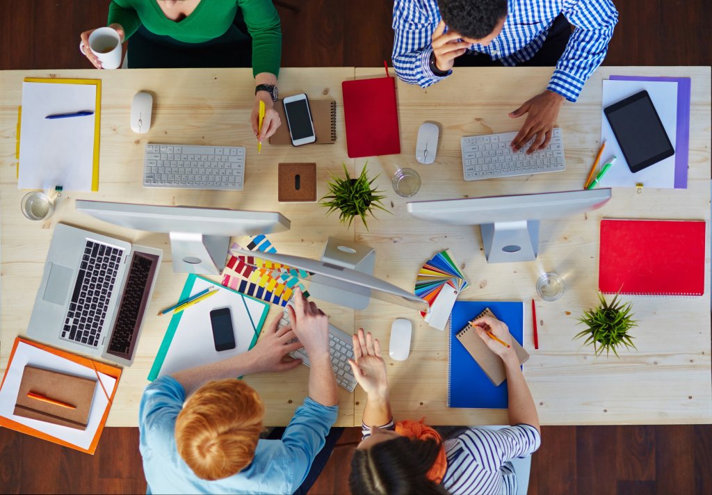 Team collaborating on design project with laptops