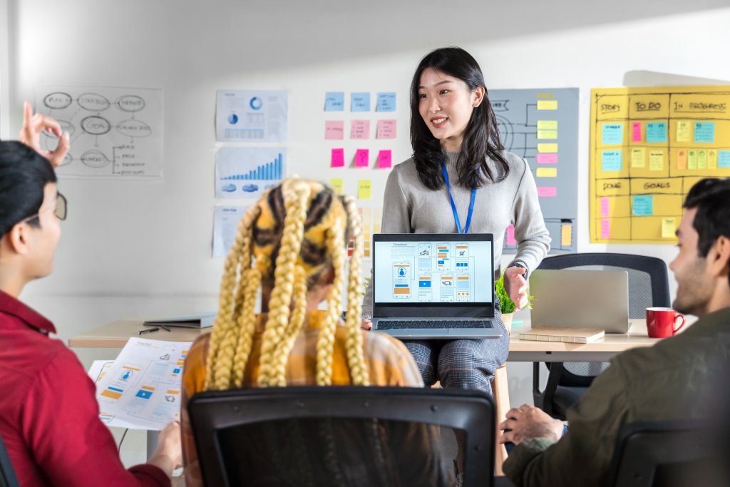 Woman presenting app design to team